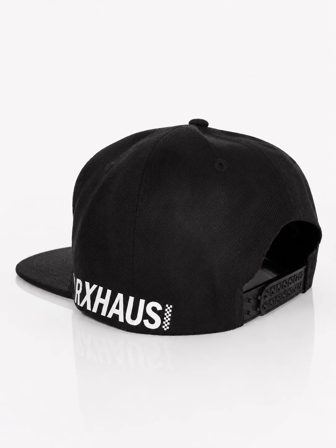 The same cap from behind, MARXHAUS printed along the side above the brim, showing the snap closure
