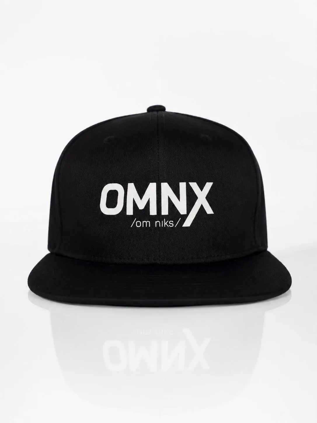 Black OMNX snapback cap seen head on, OMNX and the pronunciation /om niks/ printed across the front panels