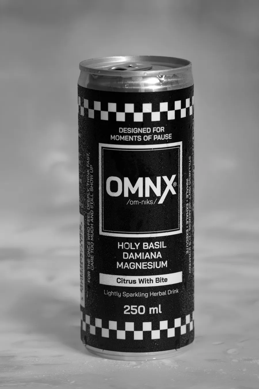OMNX can on a wet surface, covered in water droplets